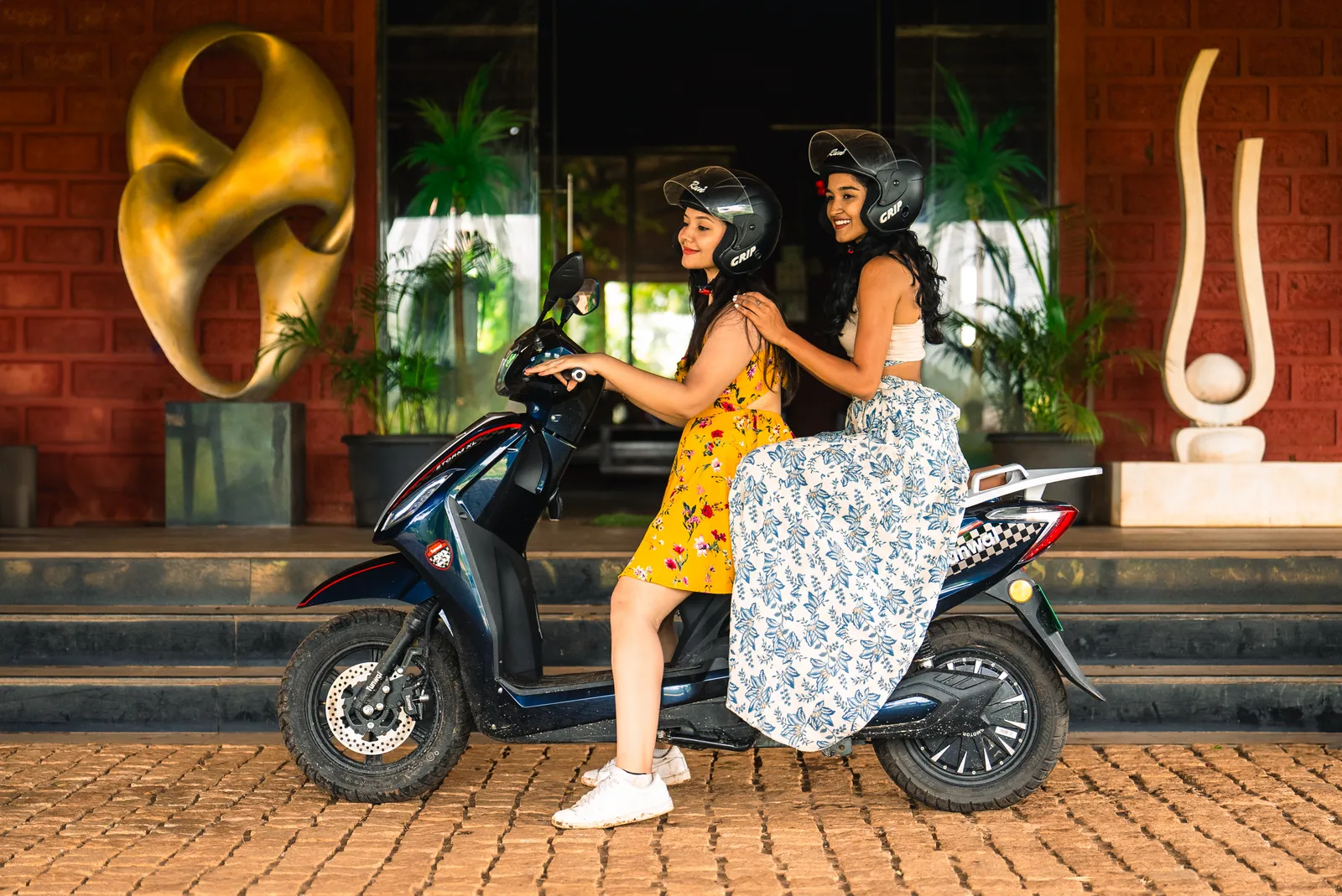 Two riders together on a Tunwal electric scooter