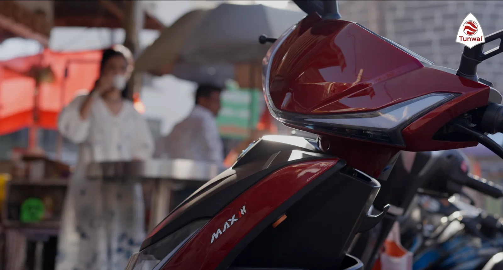 A Tunwal MAX II electric scooter on a busy city street