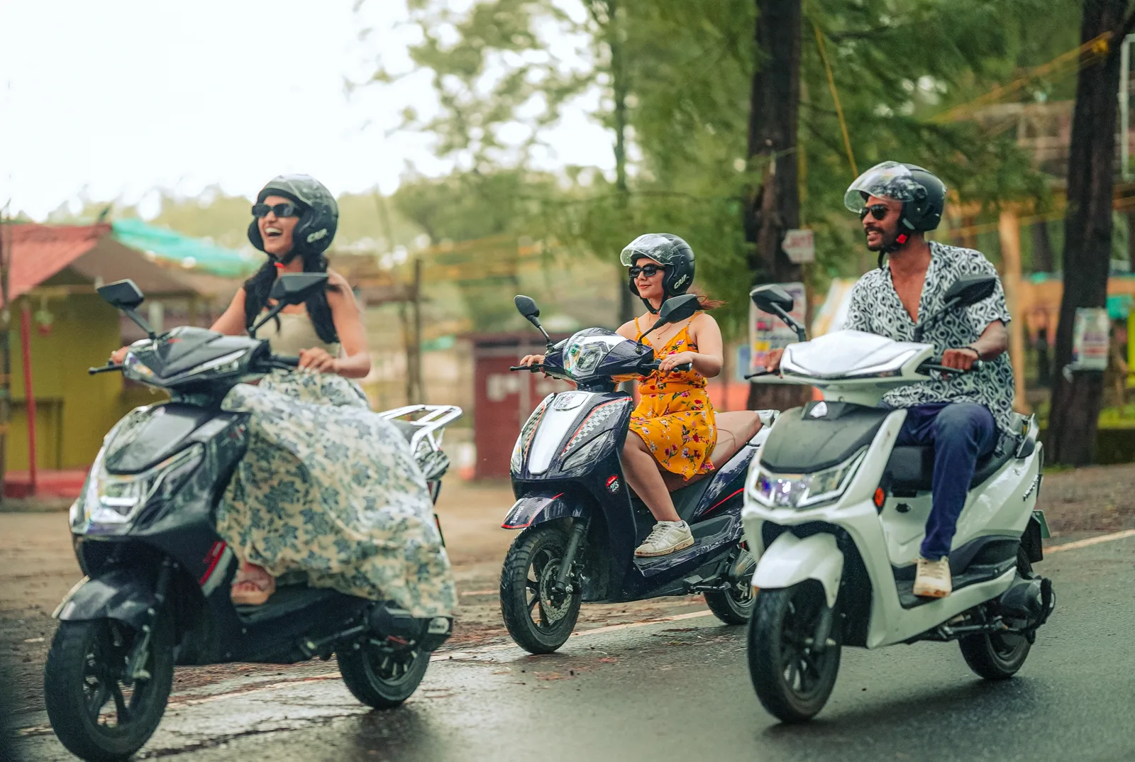 Three friends on Tunwal scooters near the coast